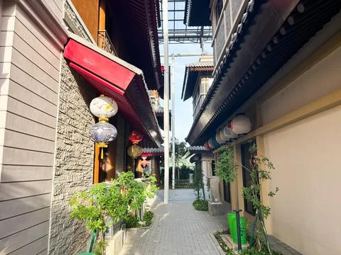 Rows of dark-framed windows, some open with white decorative railings Stock Photos