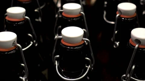 Rows of dark glass bottles with lids close up. Stock Footage 86676313