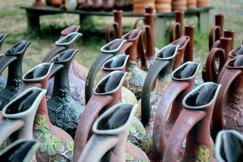 Rows of decorative clay pitchers with patterns and matte texture Stock Photos