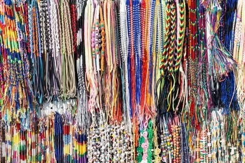 Rows of different color cloth bracelets on the market Stock Photos