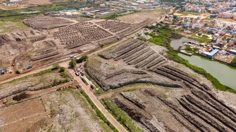 Rows Of Drying Waste And Compost At An Open Waste Management Site Beside A City Fotos de archivo