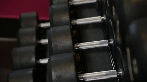 Rows of dumbbells in the gym, simulators for athletes. 库存影片 100040354