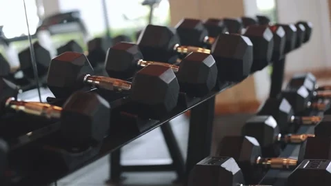 Rows of dumbbells in the gym with sunset light	 Stock Footage 140749014
