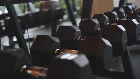 Rows of dumbbells in the gym with sunset light Stock Footage 141309265