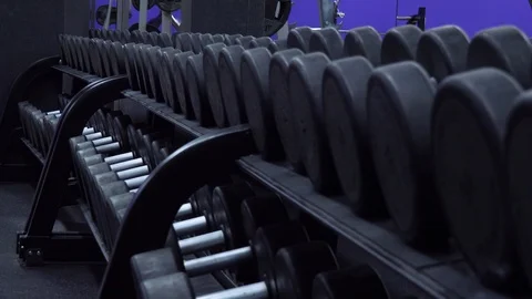 Rows of dumbbells on a rack in a gym - closeup Stock-Footage 87880411
