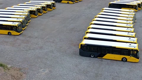 Rows of electric busses aerial view circling across industrial site parking 库存影片 342403111