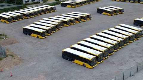 Rows of electric busses aerial view orbit left over industrial site parking 库存影片 342403143