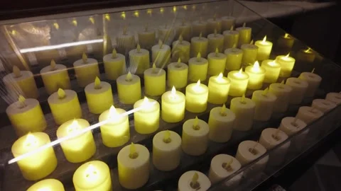 Rows Of Electronic LED Votive Candles Glowing In Dark Church Interior Vídeos de archivo 334062318