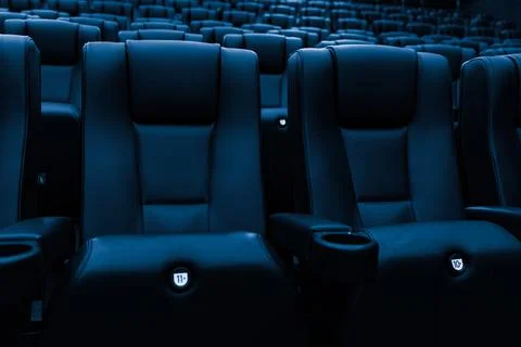 Rows of empty blue cinema seats in modern movie theater Stock Photos