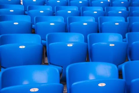 Rows empty bright blue plastic seats in a stadium Foto stock