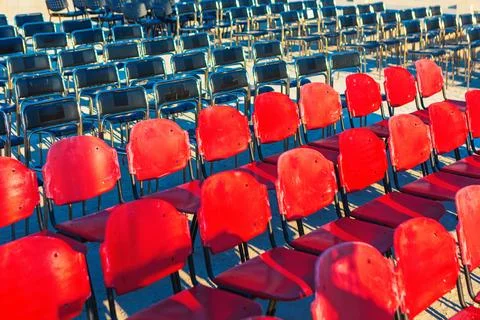 Rows of empty chairs are arranged outdoors Stock Photos