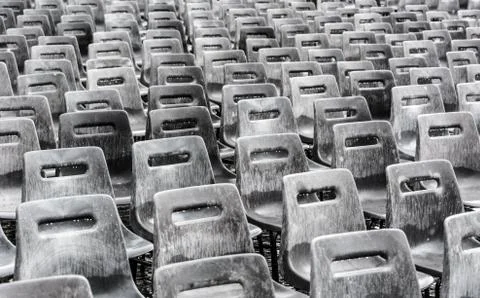Rows of empty gray chairs in the rain Stock Photos