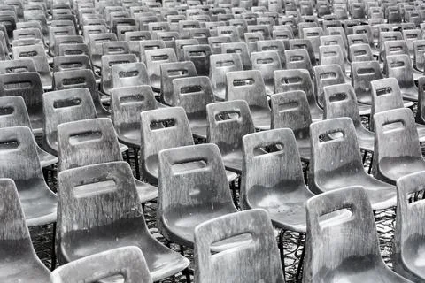 Rows of empty gray chairs in the rain Stock Photos