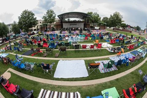 Rows of empty lawn chairs are set up for concert Stock Photos