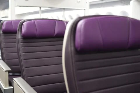 Rows of empty leather airplane seats. Stock Photos