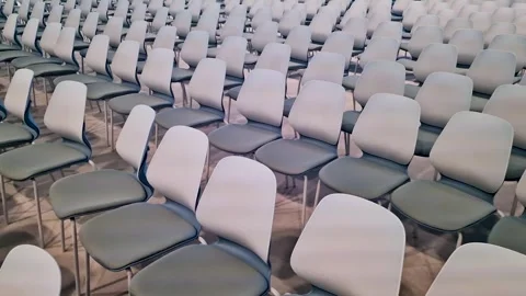 Rows of empty modern grey and white chairs arranged in a large auditorium, .. Stock Footage 335981578