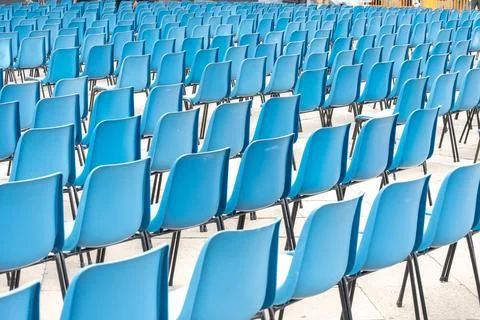 Rows of empty plastic chairs for outdoor events. Stock Photos