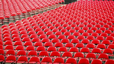 Rows of empty red chairs prepared for a large event, ceremony, graduation, or Stock Footage 337983634