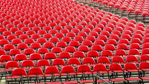 Rows of empty red chairs prepared for a large event, ceremony, graduation, or Stock Footage 338318218