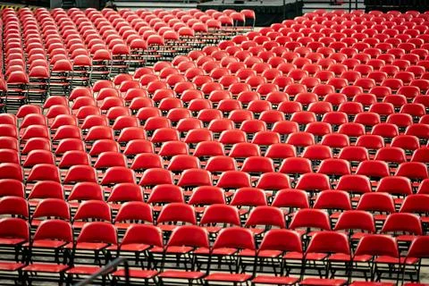 Rows of empty red chairs prepared for a large event, ceremony, graduation, or Stock Photos