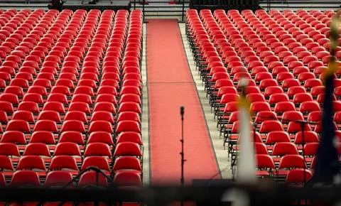 Rows of empty red chairs prepared for a large event, ceremony, graduation Stock Photos
