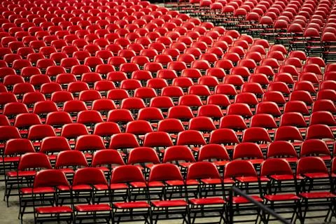 Rows of empty red chairs prepared for a large event, ceremony or graduation Stock Photos