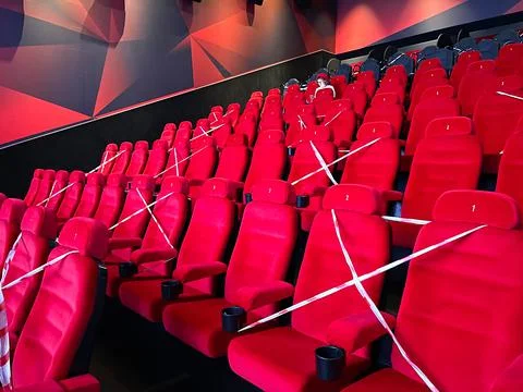 Rows of empty red cinema chairs .corona virus. Social distancing Stock Photos