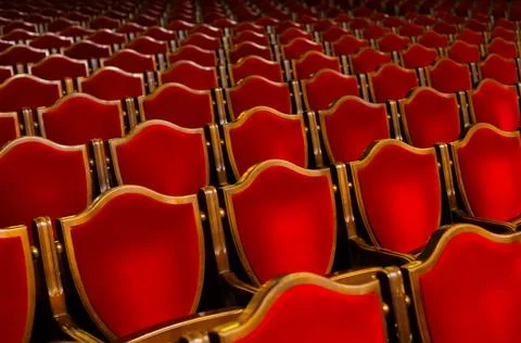 Rows of empty red old school chairs in Odessa philharmonic theater music hall Stock Photos