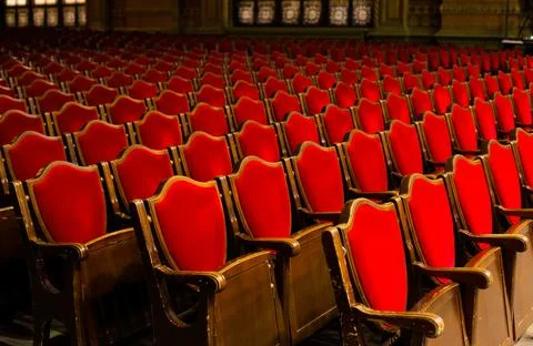 Rows of empty red old school chairs in Odessa philharmonic theater music hall Stock Photos