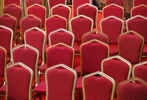 Rows of empty red seats in theater hall Stock Photos