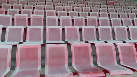Rows of empty red stadium seats with blue seats in background Vídeos de archivo 332580149