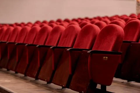 Rows of empty red theater seats in a modern performance space before the sh.. Stock Photos