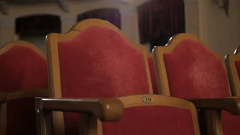 Rows of empty red velvet seats inside a theater or opera. Video stock 107407841