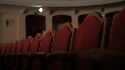 Rows of empty red velvet seats inside a theater or opera. Video stock 107408224