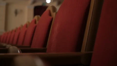 Rows of empty red velvet seats inside a theater or opera. Video stock 107408429