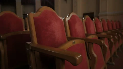 Rows of empty red velvet seats inside a theater or opera. Video stock 108385217