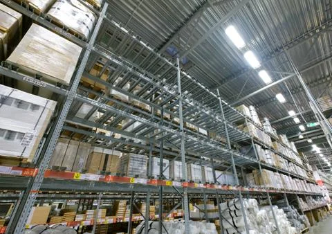 Rows of empty shelves  in modern self service warehouse in  supermarket Stock Photos