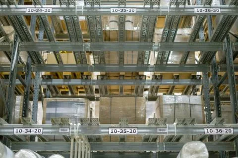 Rows of empty shelves  in modern self service warehouse in  supermarket Stock Photos
