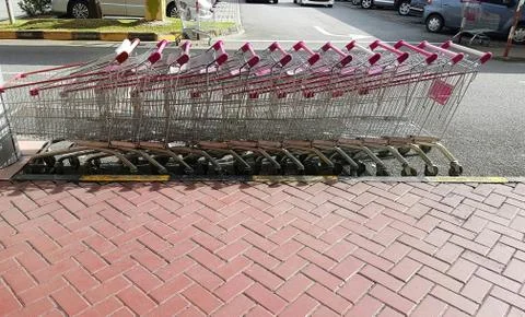 Rows of empty shopping trolleys outside mall Stock Photos
