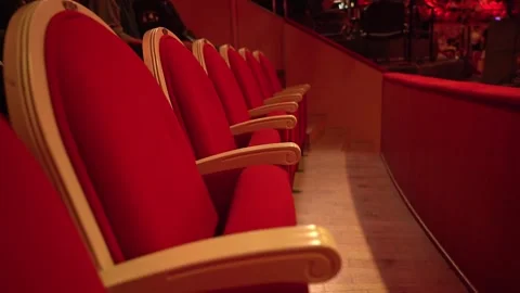 Rows of empty spectator seats in a circus or theater. red upholstered seats for Stock Footage 262040453