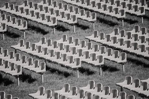 Rows of empty stadium seats on grass Stock Photos
