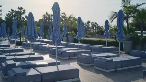 Rows of empty sun beds loungers for tanning in beach resort ready for tourists Stock Footage 304461512