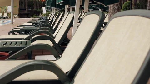 Rows of empty sun loungers stand at the pool. Stock Footage 100891806