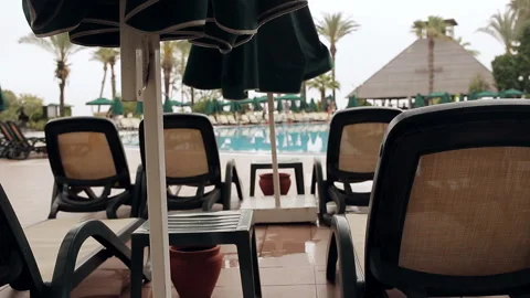 Rows of empty sun loungers stand at the pool. Stock Footage 100891893