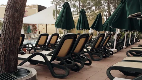 Rows of empty sun loungers stand at the pool. Stock Footage 100891948