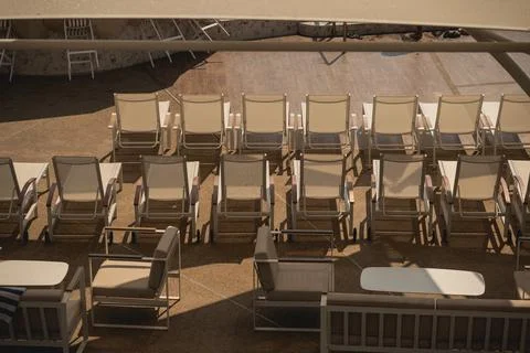 Rows of Empty Sun Loungers Under the Shade in a Relaxing Poolside Setting w.. Stock Photos
