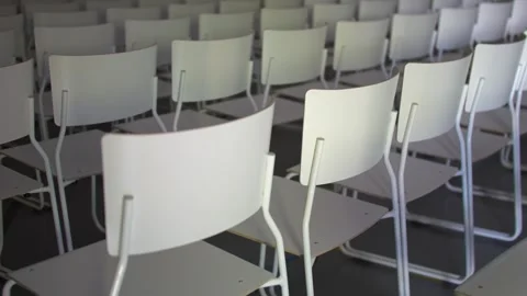 Rows of empty white chairs in modern auditorium conference room with smooth.. Stock Footage 337613451