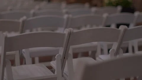Rows of empty white chairs set up for an event or ceremony Stock Footage 345260503