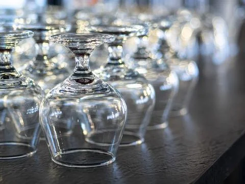 Rows of empty wine glasses on the showcase Stock Photos