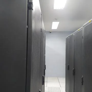 Rows of equipment racks in the telecommunication data center server room 스톡 사진
